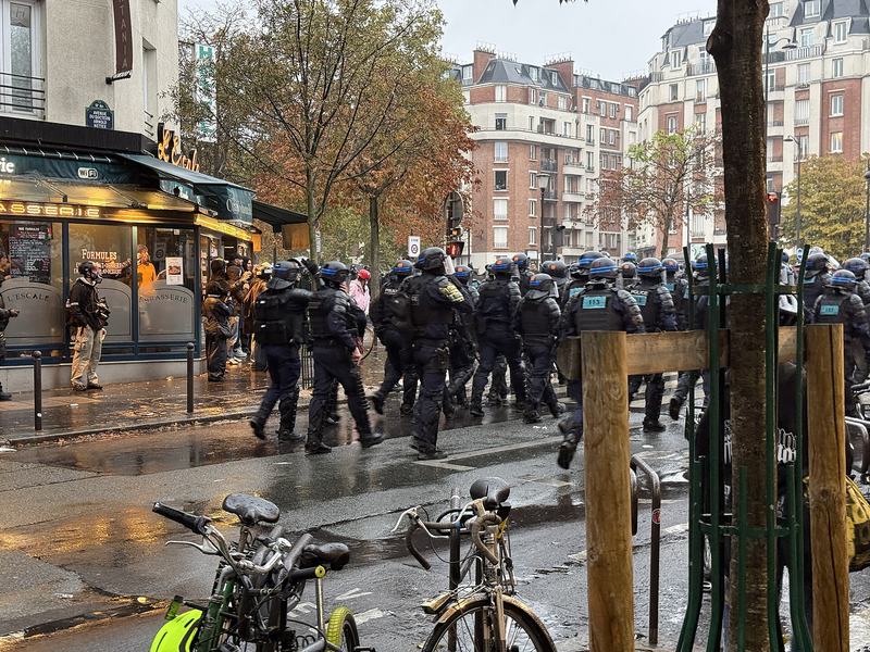 Riot police lined up on a Paris avenue during the protests of October 24, 2026